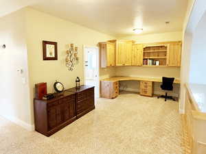 Office space with built in study area and light carpet