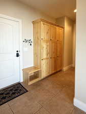 Mudroom featuring light tile patterned floors and baseboards