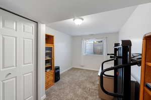 Large Bedroom/office, or exercise room, featuring light carpet, closet, and baseboards