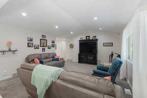 Formal entry and living area with lofted ceiling and recessed lighting