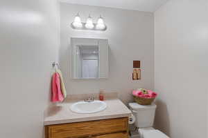 Half bath featuring vanity and toilet