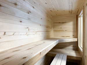 Sauna with wood walls and wood ceiling
