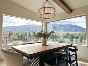 Dining space with a mountain view and chandelier.