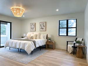 Primary bedroom featuring a fireplace, mountain views, and a sliding door out to the covered deck