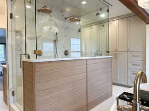 Full bath with a steam shower and a soaking tub