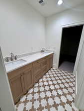 Full bathroom with double vanity and recessed lighting