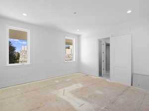 Primary bedroom featuring recessed lighting. Carpet coming soon!