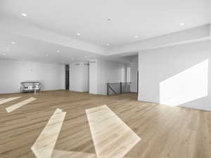 Kitchen featuring light wood-style flooring and recessed lighting. Cabinets, island, and refrigerator coming soon!