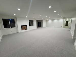 Basement featuring recessed lighting and light colored carpet