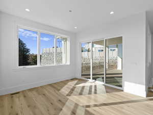 Dining knock featuring healthy amount of natural light, light wood finished floors, and recessed lighting