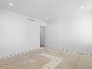 Primary bedroom featuring baseboards and recessed lighting. Carpet coming soon!