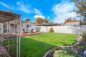 Fenced backyard with a deck and a gate