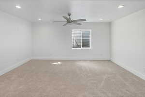 Empty room featuring light carpet, recessed lighting, and a ceiling fan