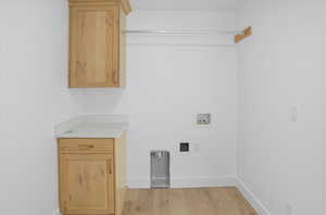Washroom featuring light wood-style floors and hookup for a washing machine