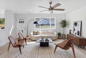 Living room featuring a ceiling fan and recessed lighting