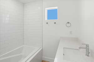 Bathroom with vanity and tiled shower / bath