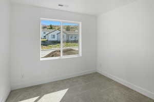 Empty room with light carpet and baseboards