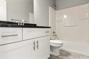 Full bathroom with vanity,  shower combination, and light tile patterned flooring