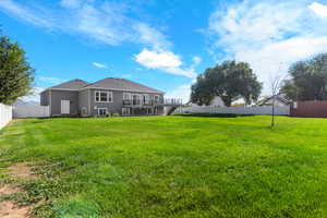 Fenced backyard featuring a deck and stairs