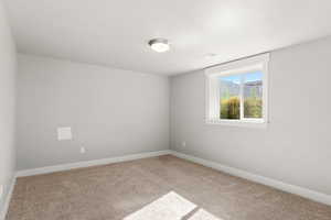 Unfurnished room with carpet and baseboards