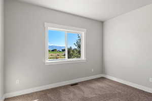 Carpeted bedroom featuring a mountain view