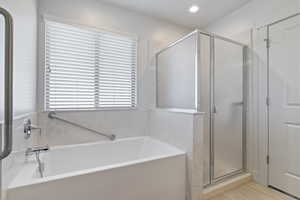 Bathroom featuring a garden tub and a stall shower