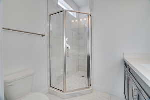 Bathroom with vanity and a shower stall