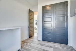 Entrance foyer with baseboards and light wood finished floors