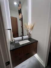 Bathroom with vanity and baseboards
