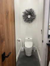 Bathroom with toilet and baseboards