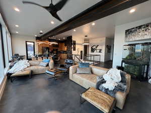 Living area with recessed lighting, a ceiling fan, and beam ceiling