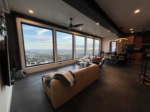 Living area with ceiling fan, recessed lighting, and finished concrete floors