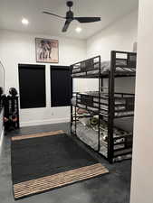 Bedroom with finished concrete flooring, ceiling fan, and recessed lighting
