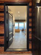 Doorway to outside with concrete flooring and recessed lighting