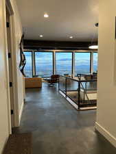 Corridor with concrete floors and recessed lighting