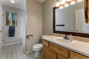 Bathroom featuring vanity and shower / bathtub combination with curtain