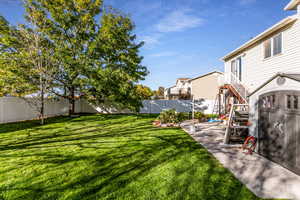 Fenced backyard featuring a residential view and stairs