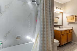 Bathroom featuring vanity, light tile patterned floors, and shower / tub combo