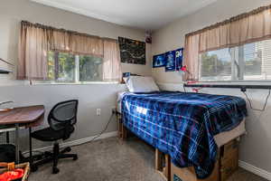 Carpeted bedroom featuring baseboards