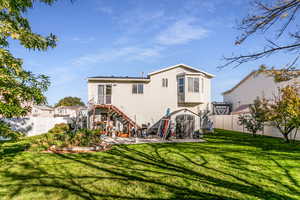 Rear view of property with stairway, a fenced backyard, and a shed