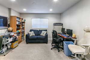 Office space featuring carpet floors and recessed lighting