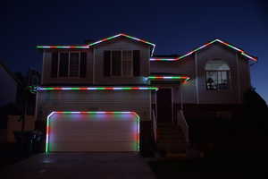 View of front of house with driveway and a garage