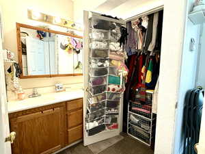 Bathroom with vanity and closet