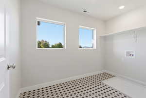 Washroom with tile patterned floors, hookup for a washing machine, and recessed lighting