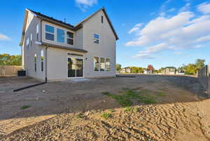 Rear view of house with a patio area and stucco siding