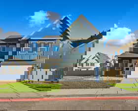 View of front of home featuring driveway and an attached garage