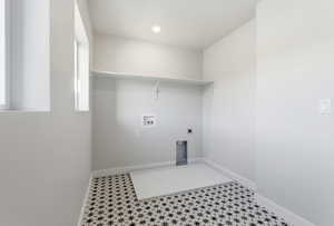 Laundry room with hookup for a washing machine, hookup for an electric dryer, tile patterned floors, and recessed lighting