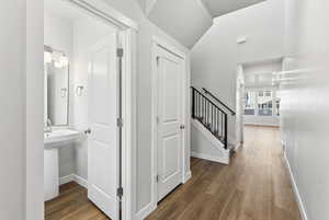 Hallway featuring dark wood-type flooring and stairs