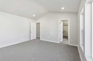 Unfurnished bedroom featuring vaulted ceiling, carpet, and recessed lighting