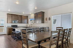 Dining area featuring dark wood-style flooring and recessed lighting